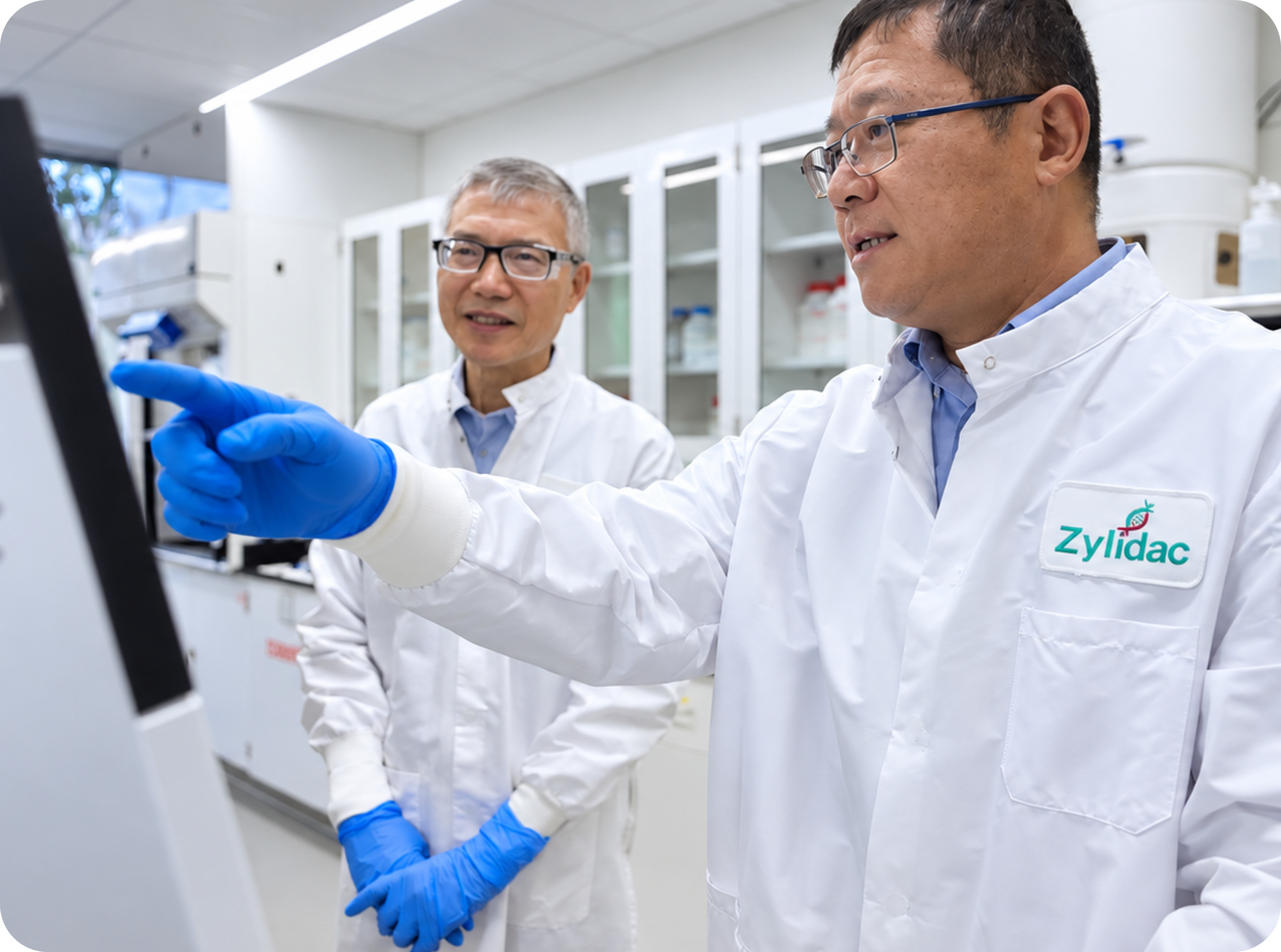 Two Zylidac scientists reviewing process information on a monitor